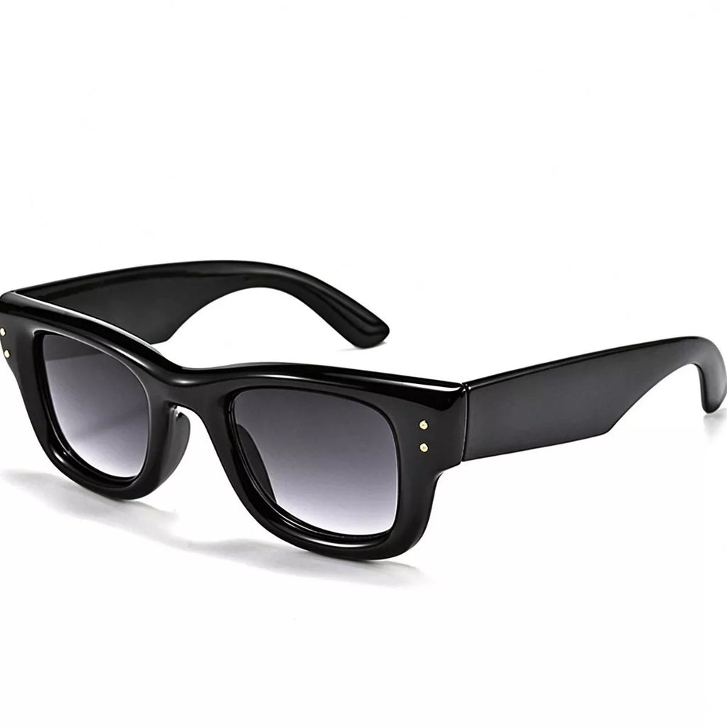 Glossy black square sunglasses with smoky gray gradient lenses, wide temples, and paired metallic corner details on a white background
