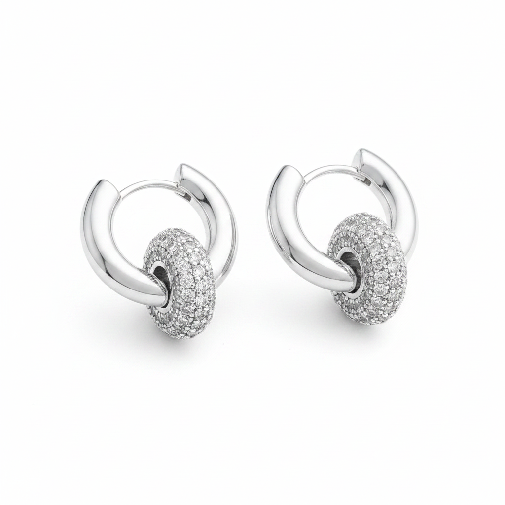 Pair of 14K white gold plated huggie hoop earrings with removable pavé cubic zirconia ball ring detail, polished silver-tone hinged hoop closure, white background, angled product view