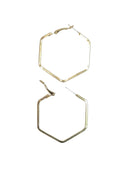 A pair of gold-toned hexagonal hoop earrings with post-back closures, displayed on a light off-white background.