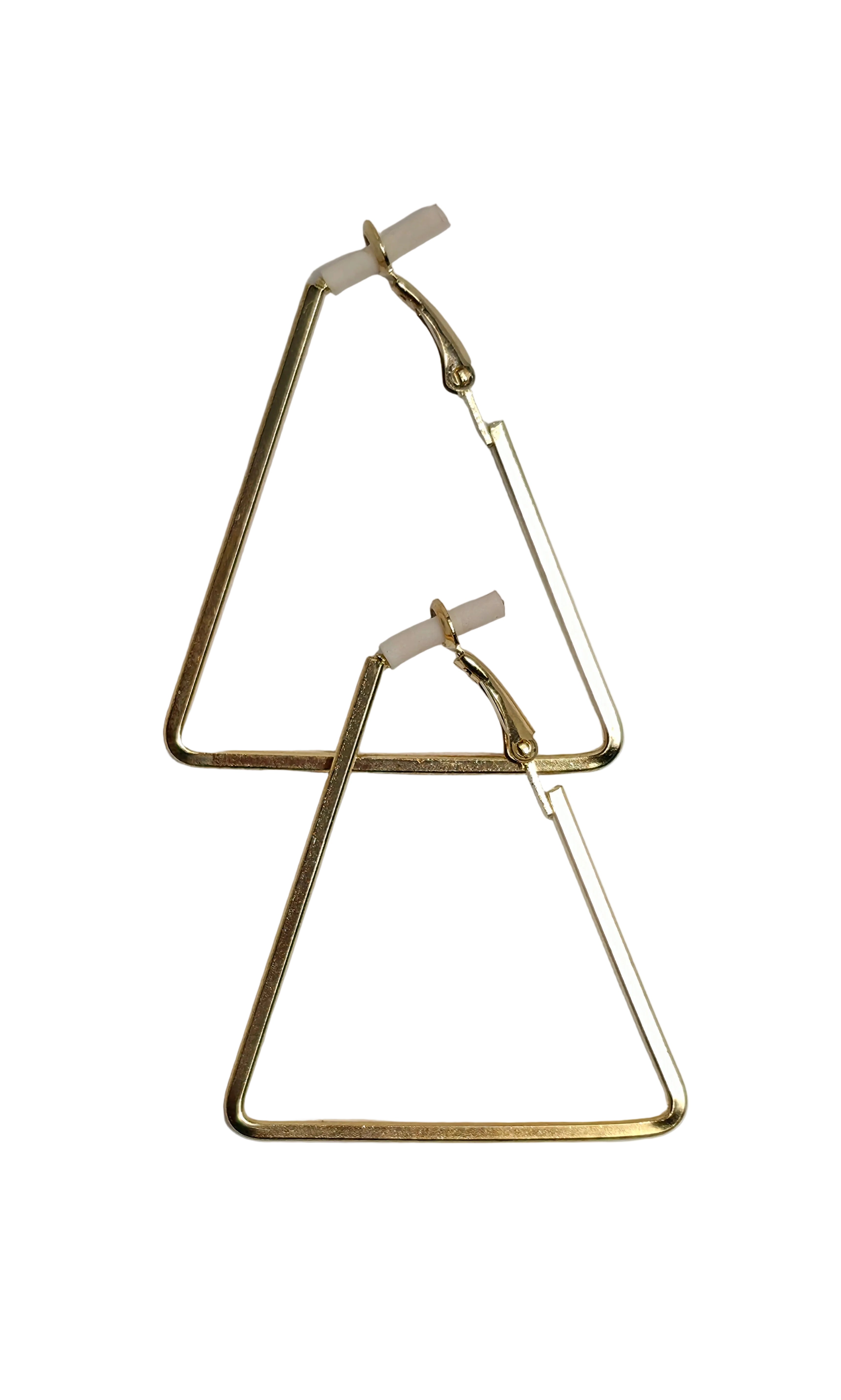 A pair of gold-toned triangle hoop earrings with small white backing caps, displayed on a light gray background.