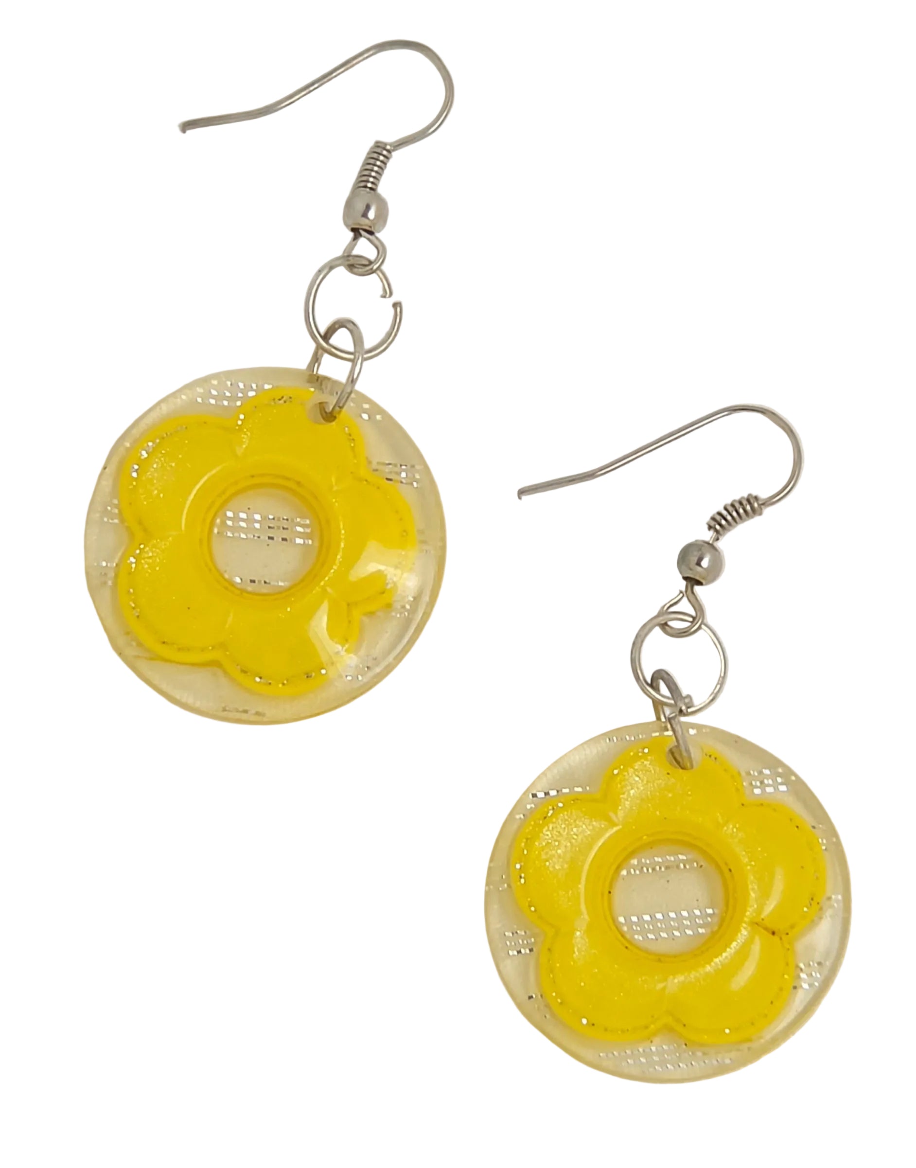 A pair of yellow flower-shaped dangle earrings with clear circular resin pendants and silver-tone fishhook wires, shown on a plain light background.