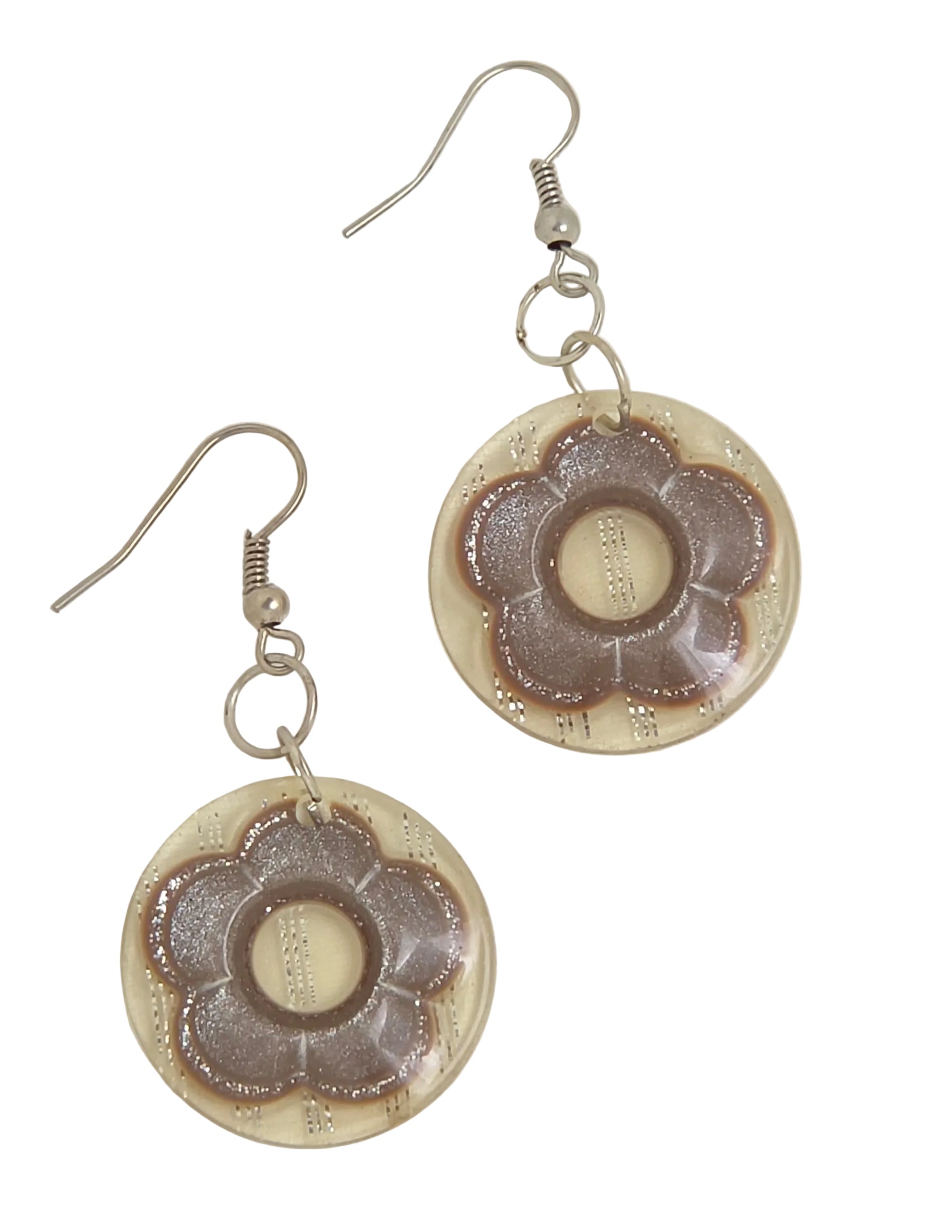 A pair of handmade dangle earrings featuring circular beige resin pendants with a raised, textured taupe-brown flower motif, suspended from silver-tone fishhook wires on a white background.