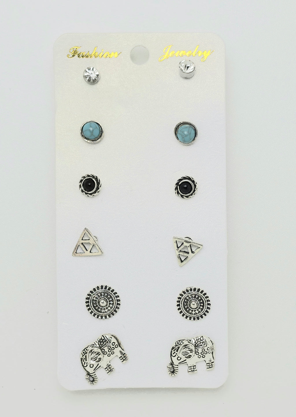 A set of 12 stud earrings displayed on a white card labeled 'Fashion Jewelry'. The earrings include silver geometric, elephant, and circular designs, as well as two light blue oval studs.