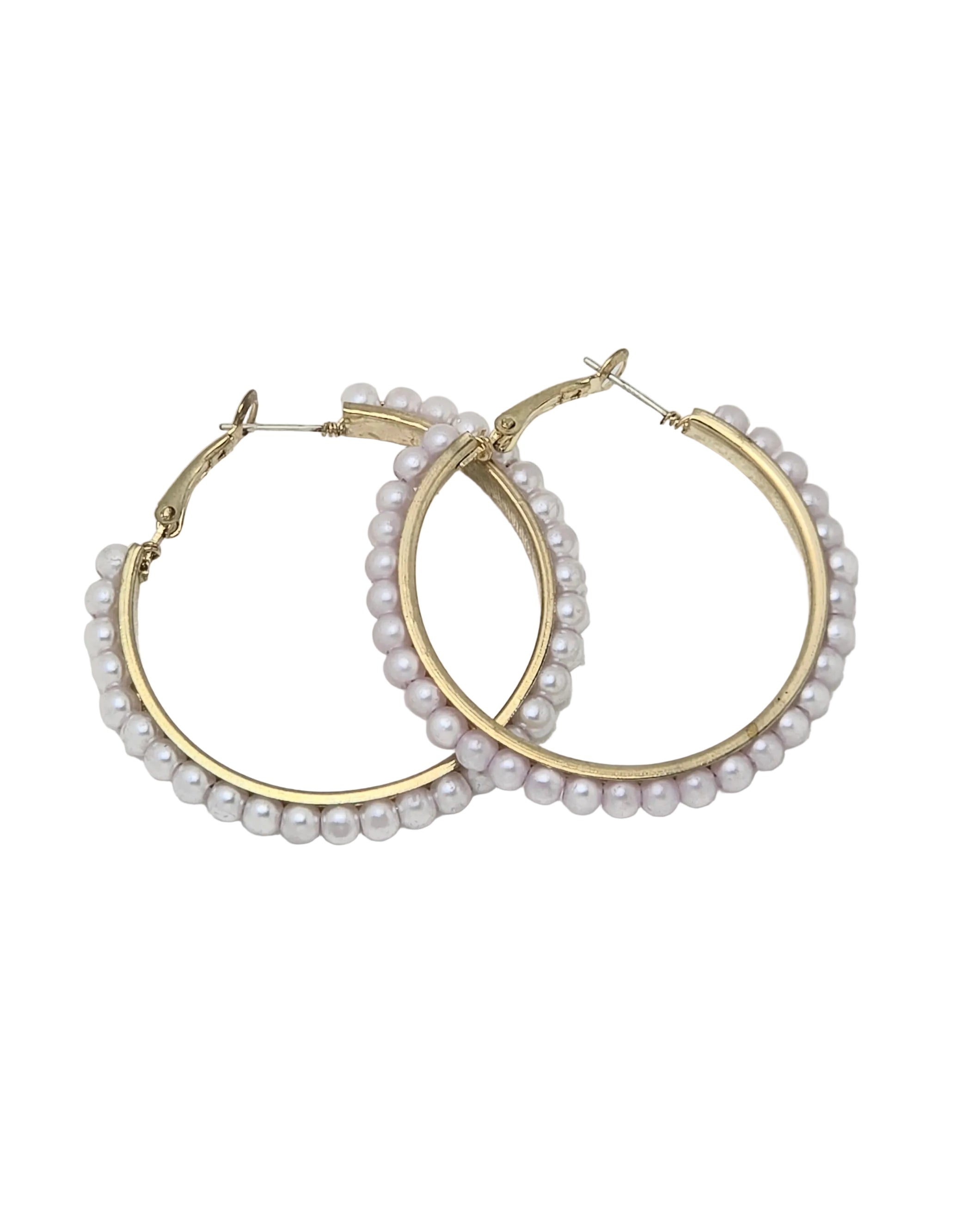 Pair of women's gold-tone hoop earrings fully lined with white faux pearl beads, hinged click-top closure, isolated on white background