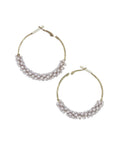 Pair of gold-tone textured hoop earrings with chunky lavender pink crystal beads wire-wrapped along the bottom half, hinged click-top closure, isolated on white background