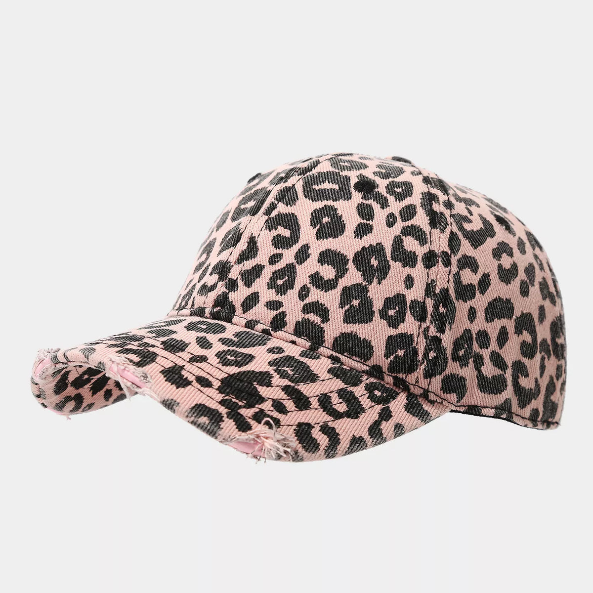 Angled view of a pink-and-black leopard print cotton baseball cap showing the paneled crown and frayed curved brim