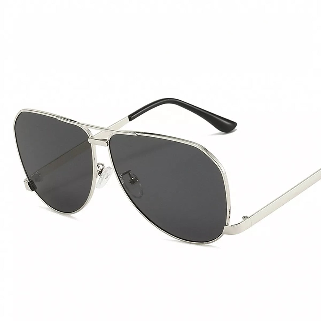 Silver-tone metal aviator sunglasses with dark gray teardrop lenses, a double bridge, clear nose pads, and black temple tips on a white background