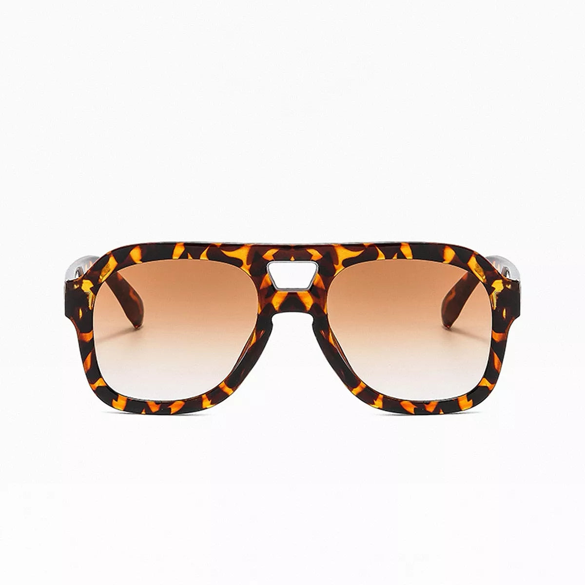 Tortoiseshell oversized aviator sunglasses with brown gradient lenses, wide patterned temples, and a cutout bridge on white