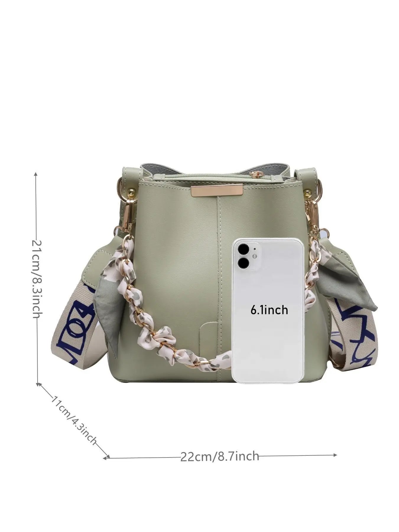 Sage green PU leather bucket crossbody bag with gold-tone chain and cream leopard print silk scarf handle, cream and navy blue letter-print wide crossbody strap, gold rectangular hardware plate, shown with 6.1-inch phone size reference — dimensions 22cm W x 21cm H x 11cm D, white background