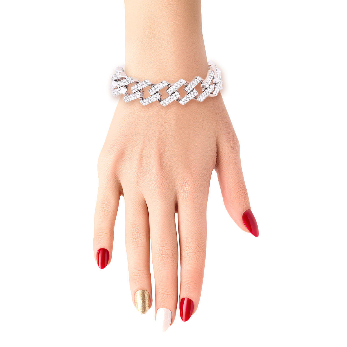 Close-up of a woman's hand and wrist with red and gold nail polish raised against a white background, wearing a wide chunky fully pave clear rhinestone square Cuban chain link bracelet in rhodium silver tone. The interlocking square links are completely covered in sparkling clear rhinestones.