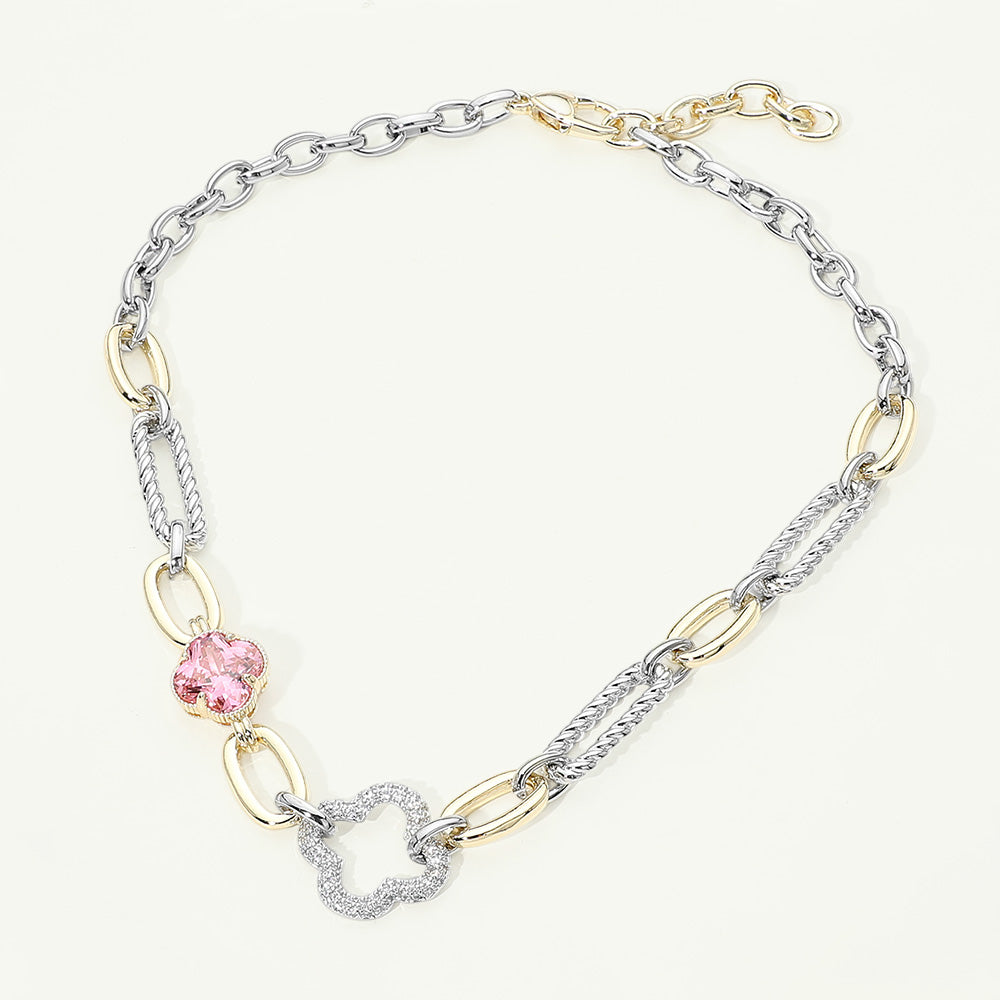 Women's 14K gold CZ pavé clover mixed link statement necklace flat lay on cream background showing full length — alternating silver twisted rope links, gold oval links, pink faceted clover stone, open CZ pavé clover pendant, and gold lobster clasp with extender