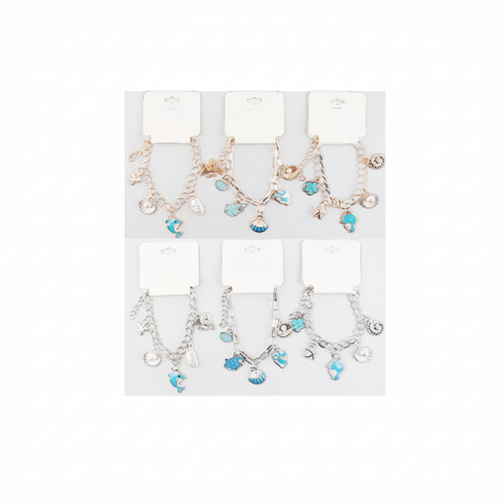 Ocean seashell charm station bracelet — 6 assorted styles on white hang-tag retail cards in two rows of three, top row gold-tone and bottom row silver-tone paperclip link chain bracelets, each featuring 5 dangling blue and teal enamel ocean charms including scallop shells, starfish, dolphins, conch shells, and oyster shells with pearl centers, light gray background