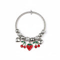Silver-tone snake chain stretch bracelet with engraved bead and silver ball spacers, featuring dangling red enamel cherry charms with green leaves, red enamel strawberry heart charm, and silver heart charms, white background