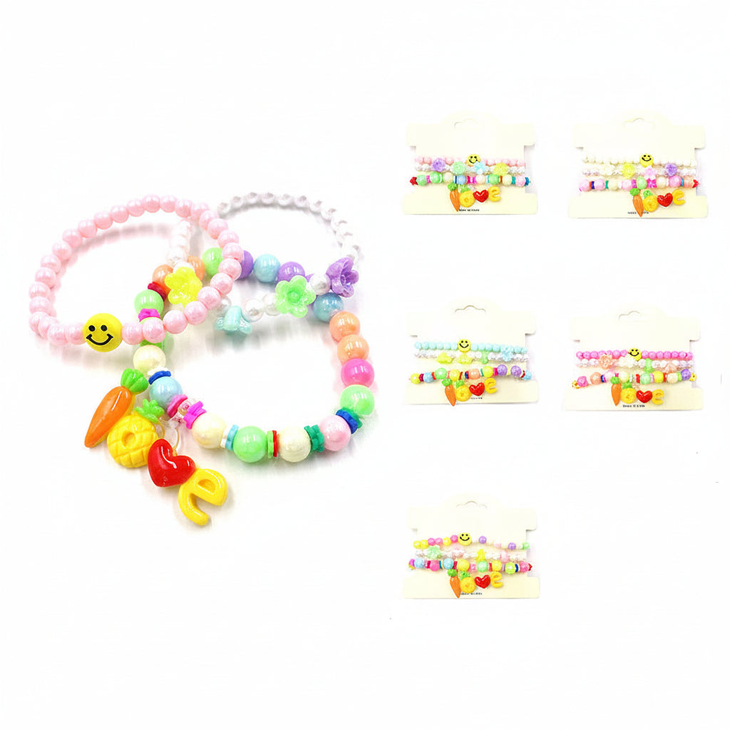 Five pairs of colorful beaded baby bracelets with cartoon charms, including smiley faces, carrots, hearts, and letters, shown with one bracelet worn on a baby's wrist and four packaged options on a white background.