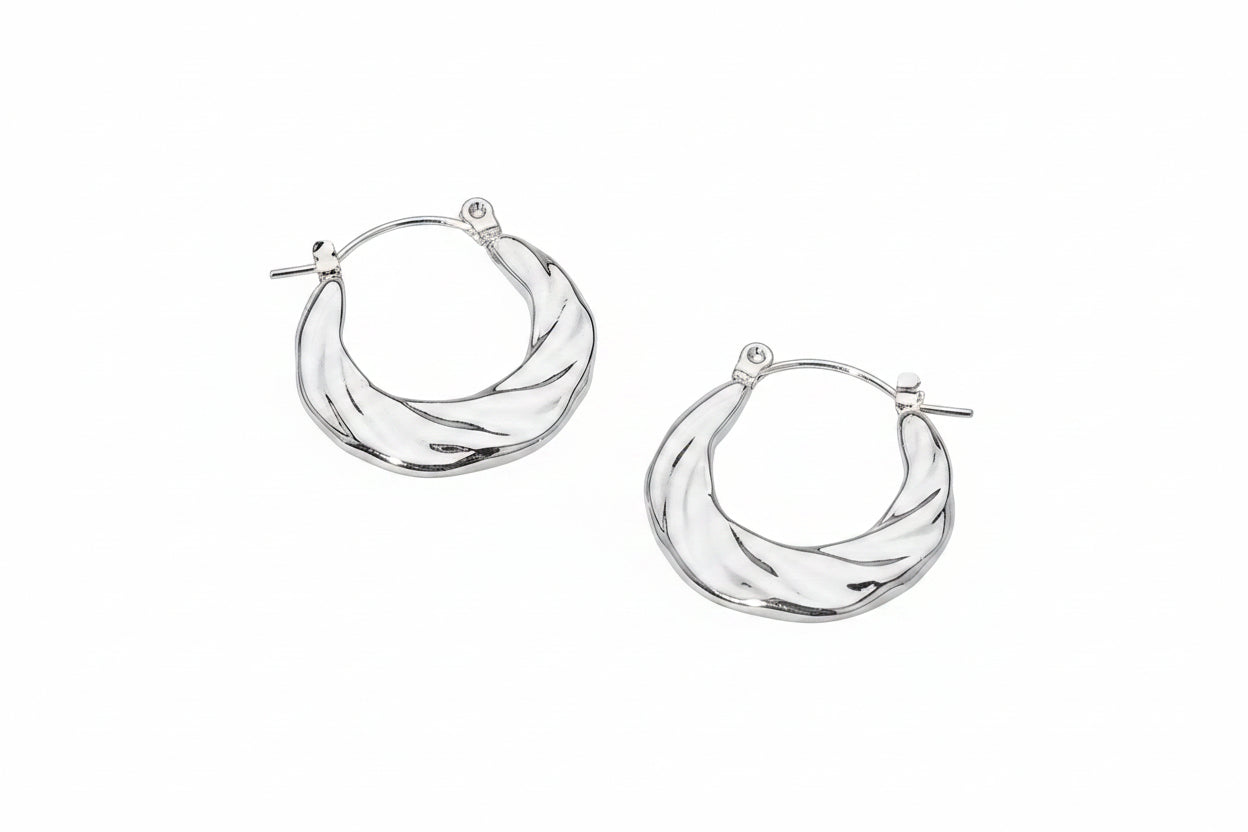 Pair of stainless steel textured twist hoop earrings in polished silver-tone — chunky rounded hoop with diagonal twist groove texture and hinged pin catch closure, shown from front and side angle, white background