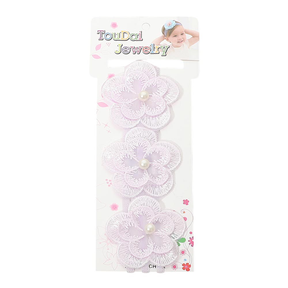 Kids floral lace stretch headband in lavender on white floral retail card — three layered lavender lace flower accents with pearl bead centers, white background