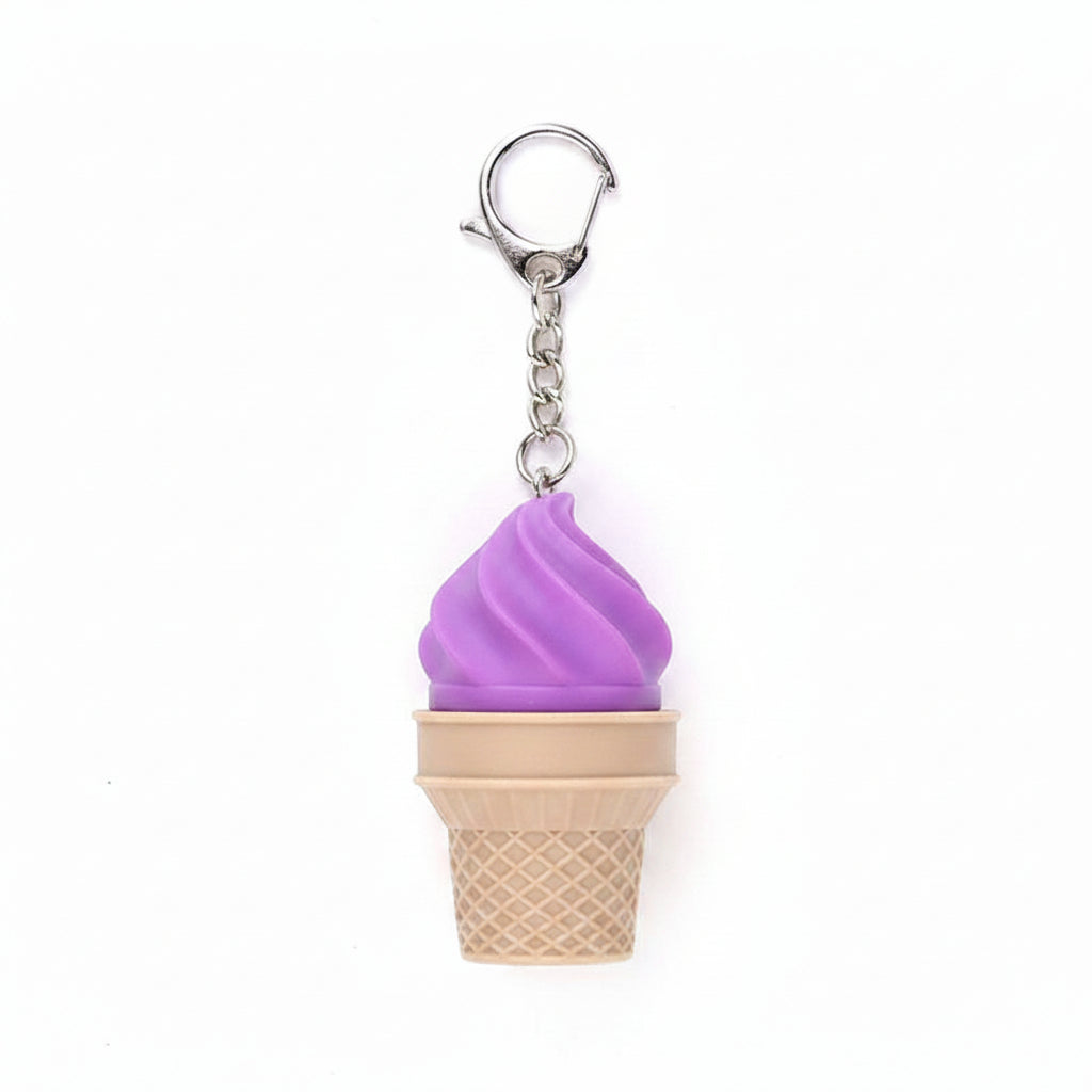 Purple soft-serve swirl plastic ice cream cone fidget clicker keychain with tan waffle cone base, silver chain, and silver lobster clasp clip, white background