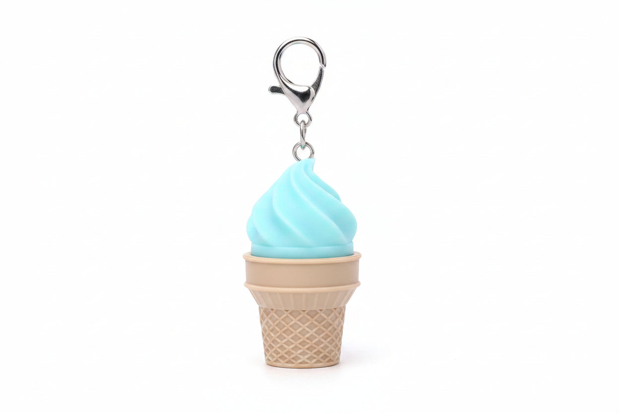 Green soft-serve swirl plastic ice cream cone fidget clicker keychain with tan waffle cone base, silver chain, and silver lobster clasp clip, white background