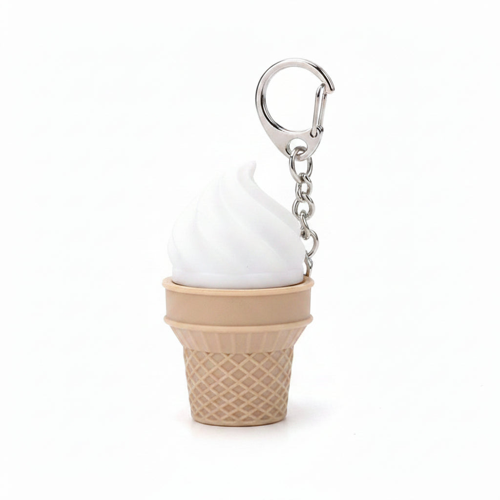 White soft-serve swirl plastic ice cream cone fidget clicker keychain with tan waffle cone base, silver chain, and silver lobster clasp clip, white background