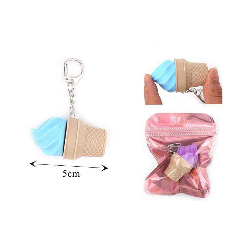 Light blue plastic ice cream cone fidget clicker keychain 5cm with silver lobster clasp, inset showing hand squeezing blue variant and purple variant inside pink resealable zip pouch packaging, white background