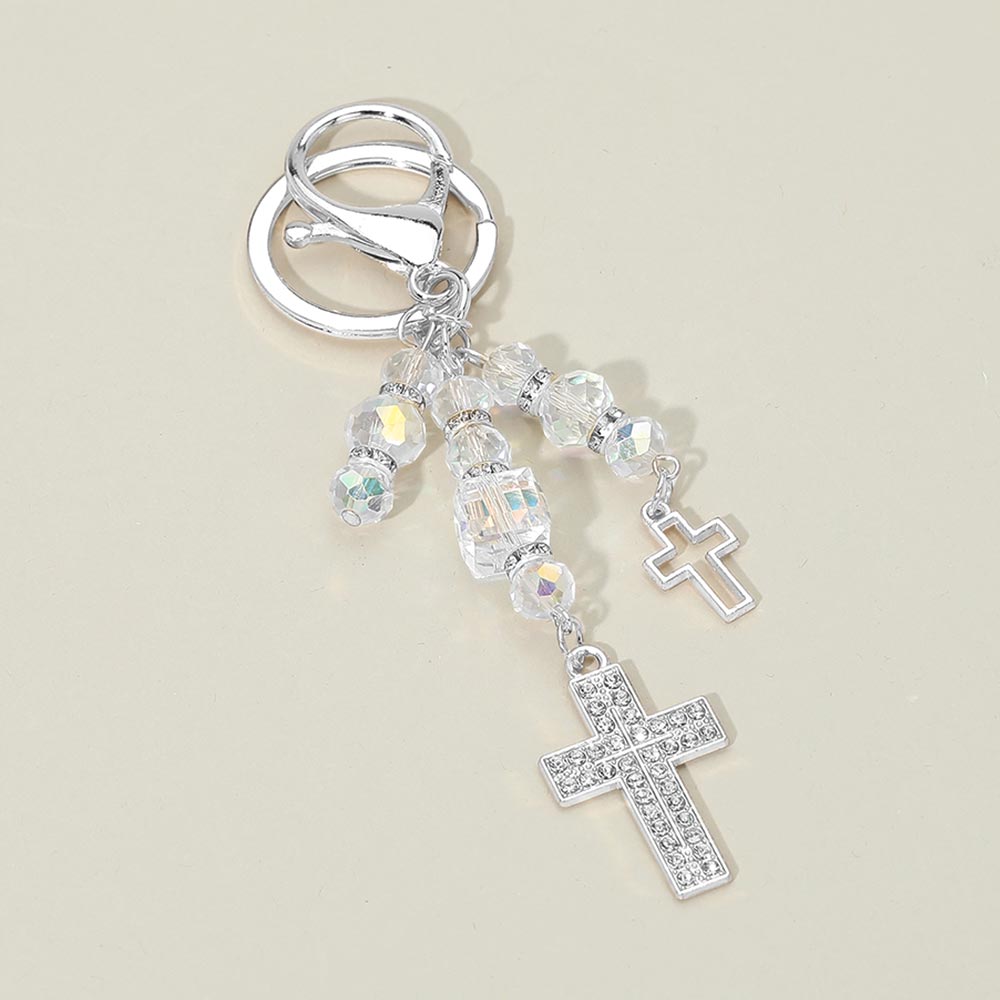 Double rhinestone cross charm drop bag charm keychain with iridescent AB crystal faceted beads and silver rhinestone spacers, silver-tone open cross and pavé rhinestone cross pendants, silver lobster clasp and key ring, warm beige background