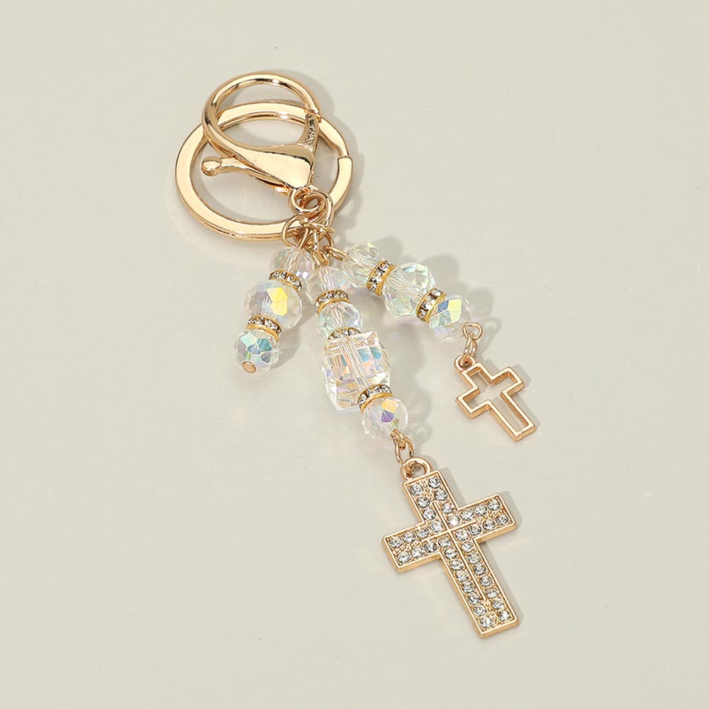 Double rhinestone cross charm drop bag charm keychain with iridescent AB crystal faceted beads and gold rhinestone spacers, gold-tone open cross and pavé rhinestone cross pendants, gold lobster clasp and key ring, warm gray background
