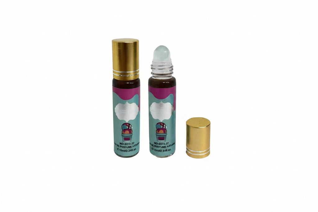 Two 10ml mini eau de parfum roller bottles with teal blue and white vanilla gourmand ice cream label — one capped with gold cap, one uncapped showing white glass roller ball, gold cap placed beside bottle, white background
