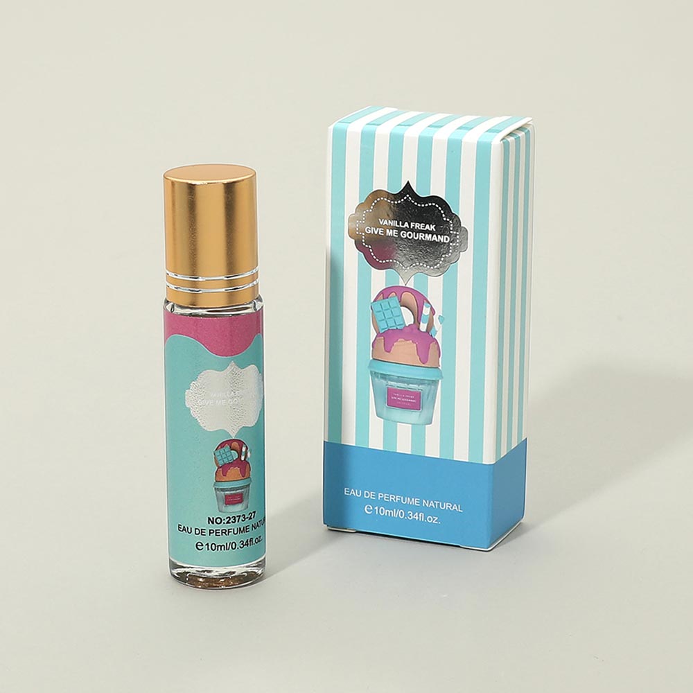 10ml mini eau de parfum roller bottle with gold cap next to teal blue and white striped gift box reading Vanilla Freak Give Me Gourmand, Eau de Parfum Natural 10ml label, warm gray background
