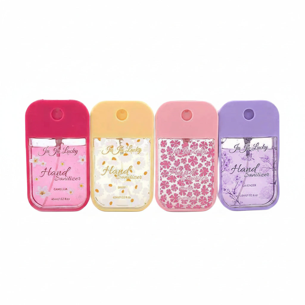 Four Ju Ju Lucky pocket hand sanitizer spray bottles 45ml side by side — hot pink silicone case with pink camellia print, yellow silicone case with orange daisy print, light pink silicone case with cherry blossom print, lavender silicone case with purple botanical print — white background