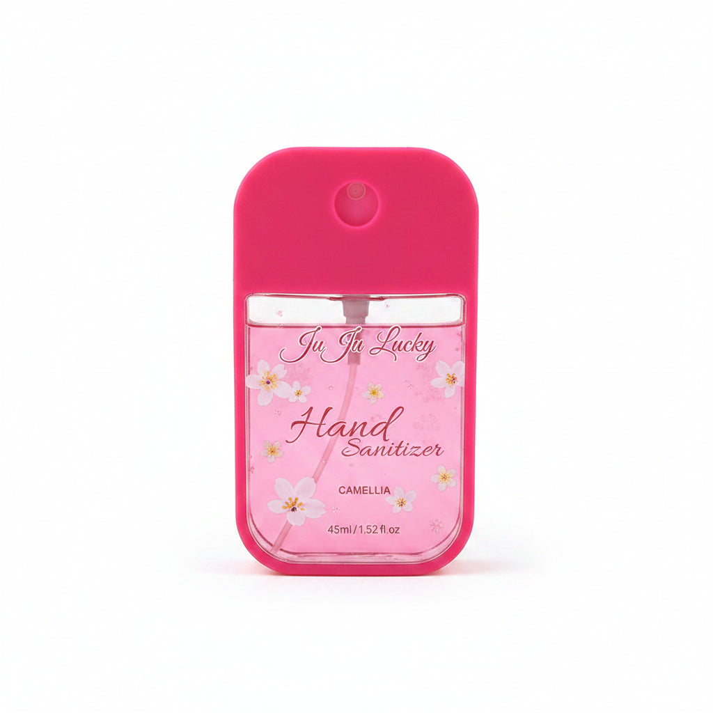 Ju Ju Lucky pocket hand sanitizer spray 45ml in hot pink silicone case with pink background and white camellia flower print label reading Ju Ju Lucky Hand Sanitizer Camellia 45ml/1.52fl.oz, circular spray nozzle on top, white background