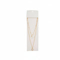Crystal clear beaded layered necklace with gold satellite chain and open-frame gold quatrefoil clover pendant on white display card, white background