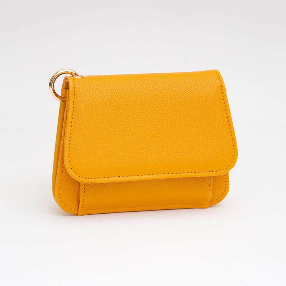 Women's mustard yellow pebble leather compact card wallet with snap flap closure, exterior coin pocket, and gold ring hardware — angled view on white background