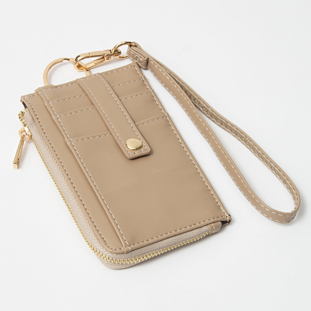 Beige wallet with keychain and strap on a white background