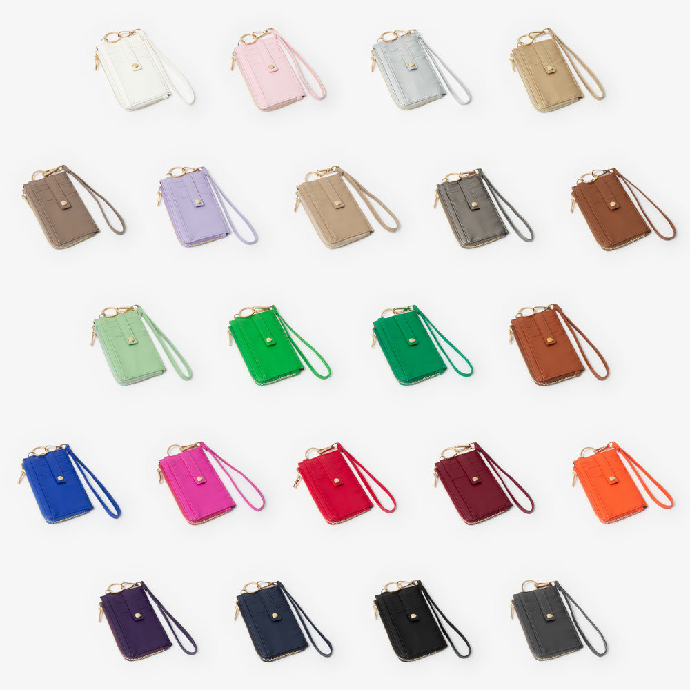 Collection of colorful small handbags with wristlets on a white background
