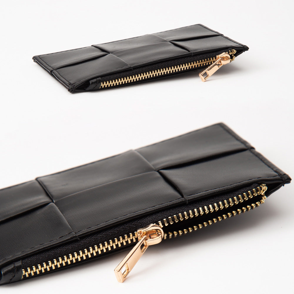 Black leather clutch with gold zipper on a white background