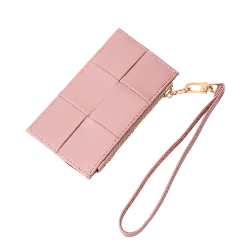 A light pink faux leather wristlet clutch with a geometric stitched pattern, a gold-tone zipper, and a matching wrist strap with a gold clasp, shown on a plain white background.