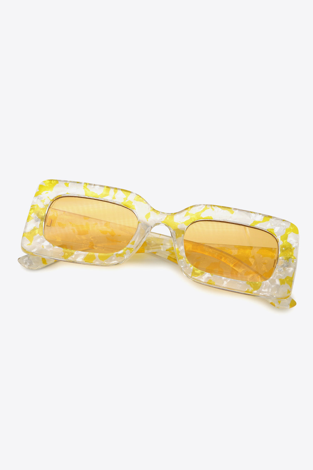 Butter Yellow rectangle sunglasses with yellow-and-clear patterned frames, shown with temples folded