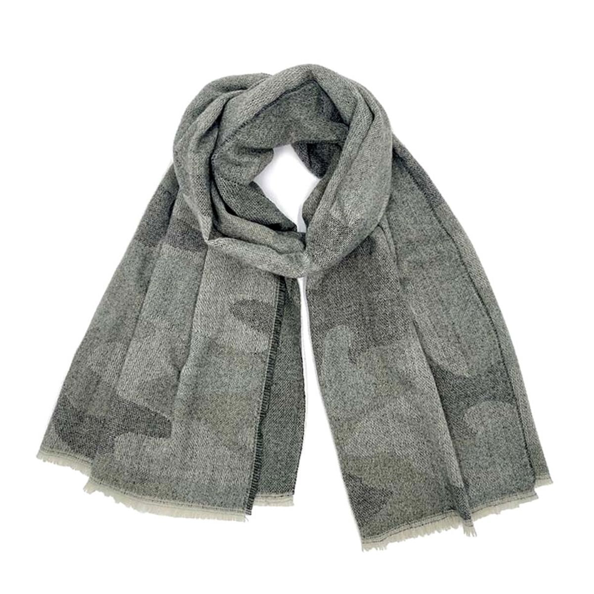 Faded gray camouflage knit scarf loosely looped on a white background, showing its wide shape, charcoal pattern, and pale fringed ends