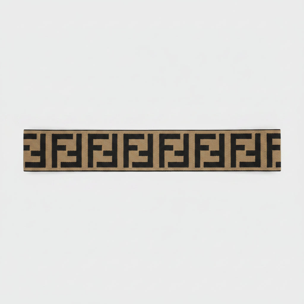 Brown wide elastic headband with geometric interlocking print pattern on white background