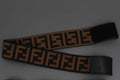 Black and brown wide elastic headbands with geometric interlocking print showing velcro closure detail