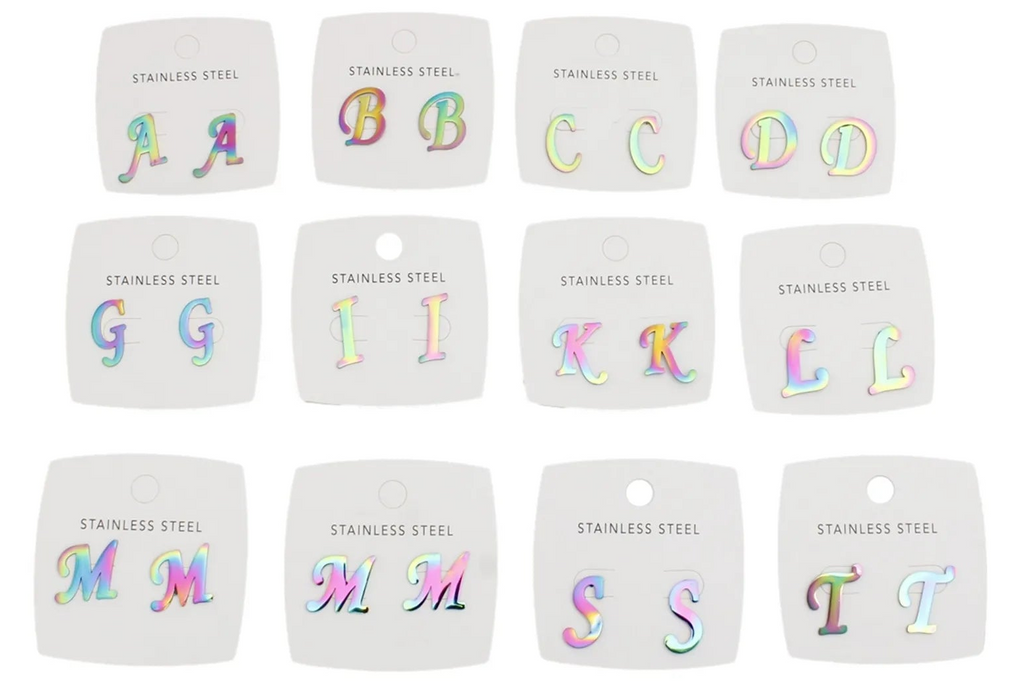 Twelve small stainless steel alphabet letters A through T, each mounted on a white backing card labeled 'STAINLESS STEEL.' The letters have an iridescent rainbow finish and are arranged in three rows of four on a plain white background.