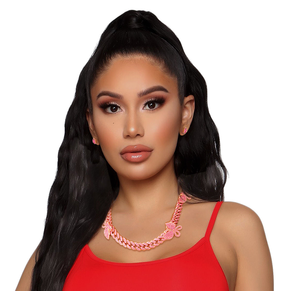 Woman with long black hair in high ponytail wearing pink rhinestone rose gold butterfly Cuban chain necklace and matching pink butterfly stud earrings, red spaghetti strap top, white background