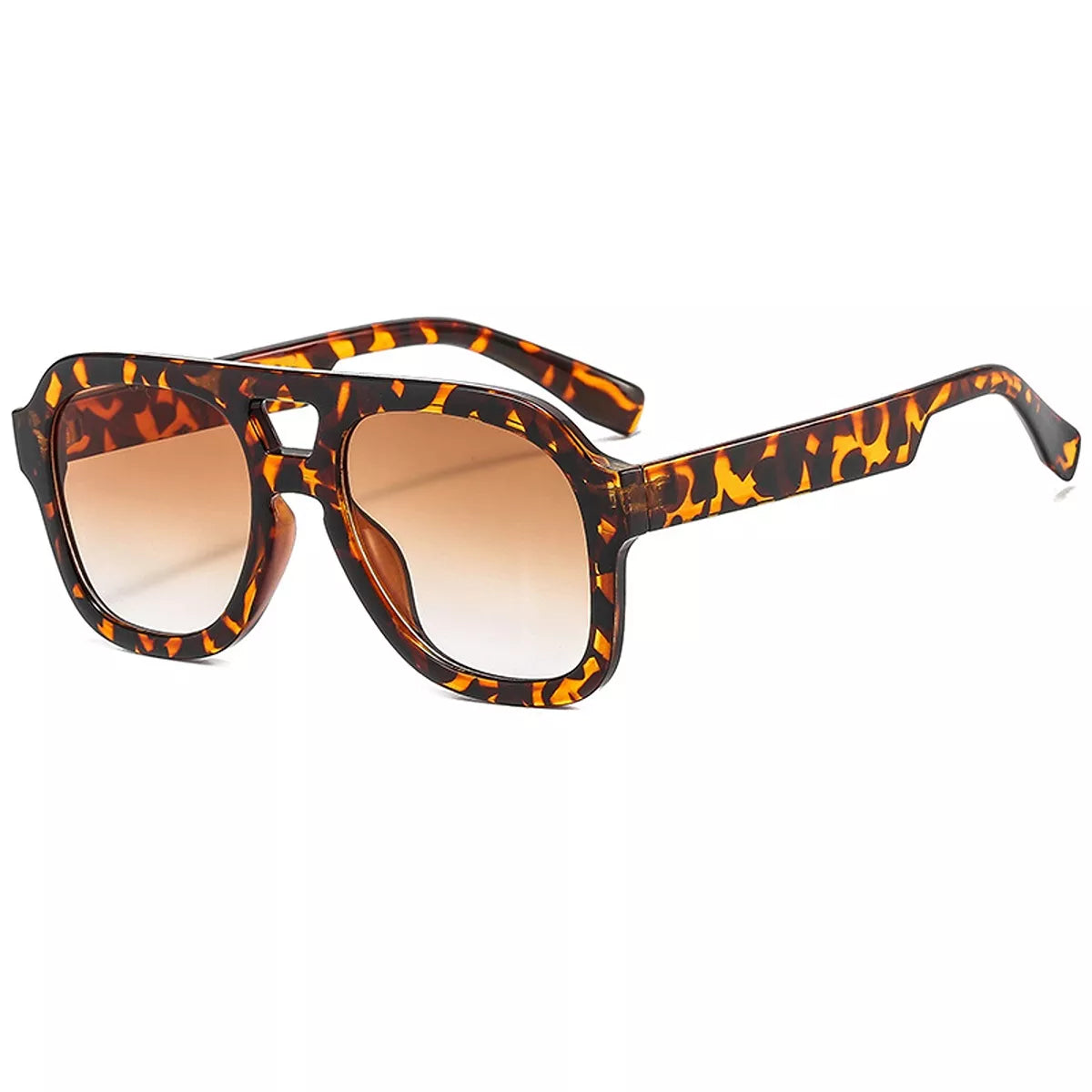 Front view of tortoiseshell oversized aviator sunglasses with brown gradient lenses and a cutout bridge on white