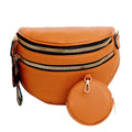 Front view of a camel brown pebbled vegan leather sling belt bag with two gold zippers, rainbow woven LOVE pull tabs on the left, and a matching round camel zip coin purse with a gold clip resting in front