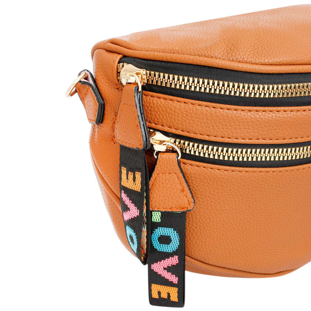 Close-up of the two gold zippers and the rainbow woven LOVE pull tabs in pink, orange, teal, and green against the pebbled camel leather