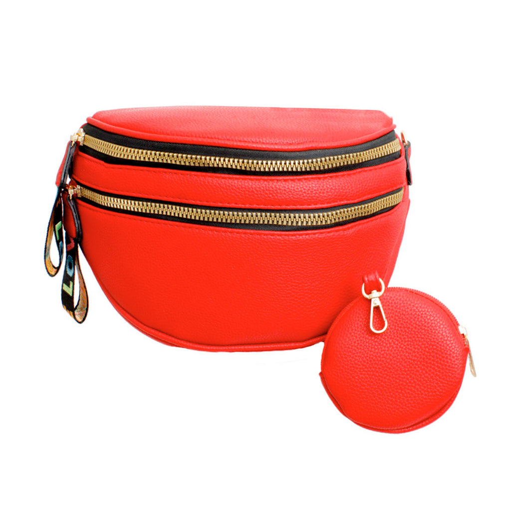Front view of a bright red pebbled vegan leather sling belt bag with two gold zippers, a rainbow woven LOVE pull tab on the left, and a matching round red zip coin purse with a gold clip beside it