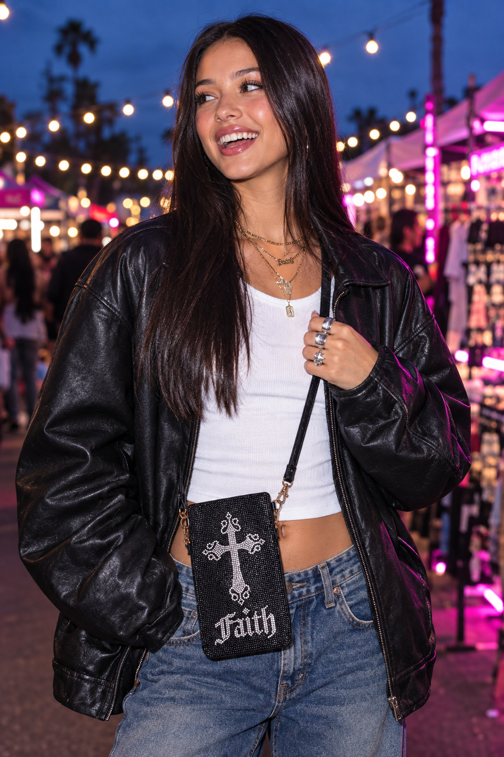 Gen Z model wearing the black rhinestone cross phone crossbody at a night market