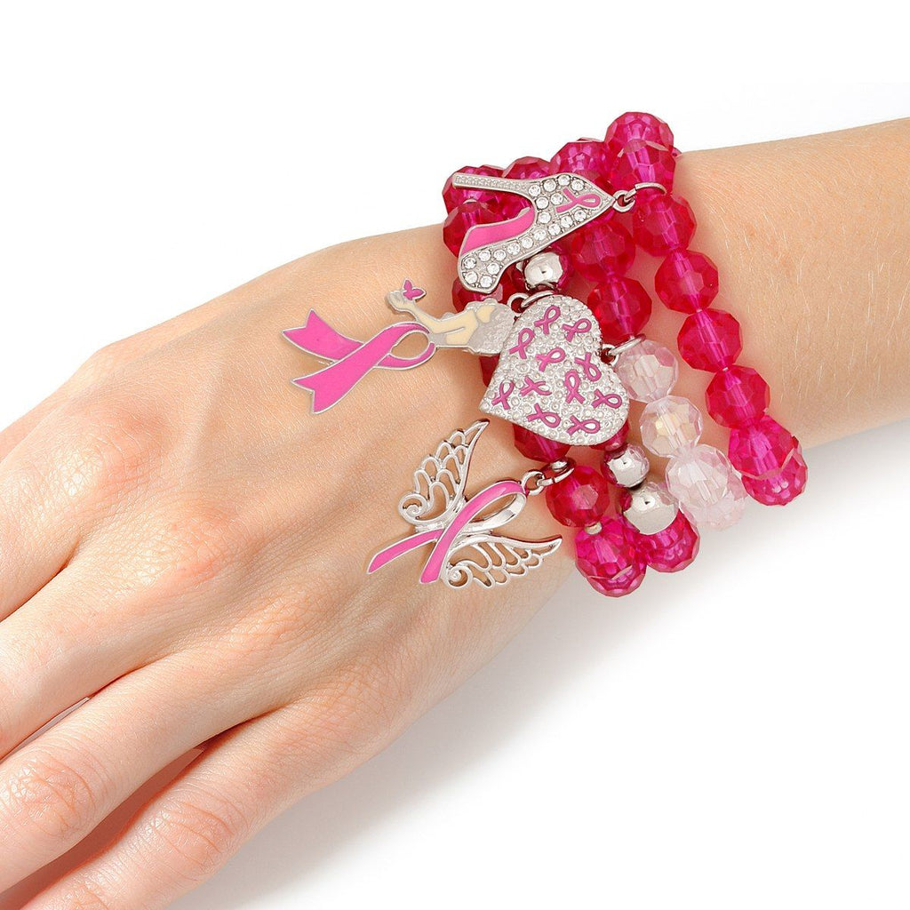 Fuchsia glass bead charm bracelet set stacked on a woman's wrist, showing angel wings, rhinestone pink ribbon heart, rhinestone high heel and woman silhouette charms