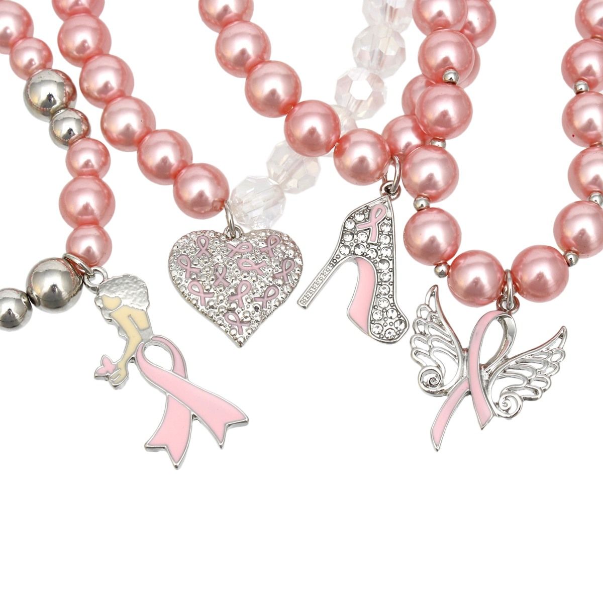 Close-up of pink ribbon charms on light pink pearl bracelets: woman silhouette, heart textured with pink ribbons, rhinestone high heel and angel wings
