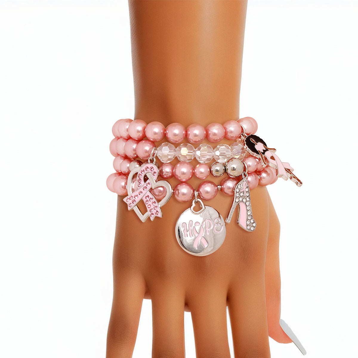  Light pink pearl charm bracelet set stacked on a woman's wrist, showing engraved Hope disc, pink rhinestone ribbon heart, rhinestone high heel and Afro woman charms